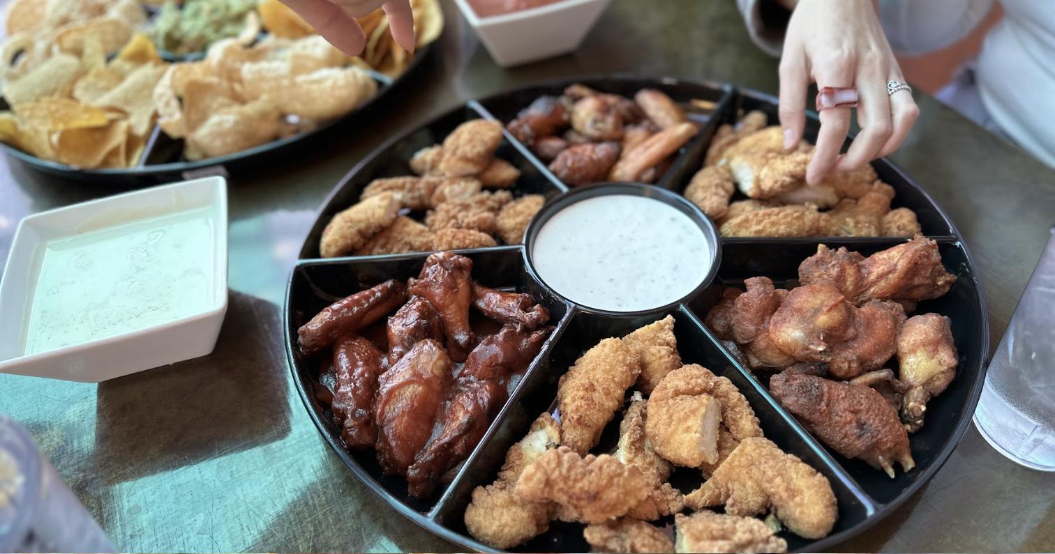 A platter of wings and chicken fingers with ranch