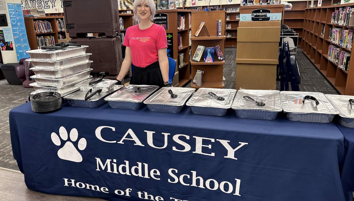 An Aztecas team member serving a sponsored lunch at Causey Middle School