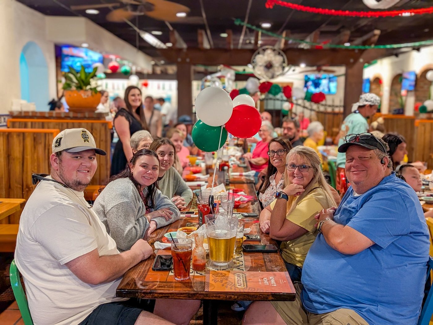 A long table of guests celebrating at Tillman's Corner