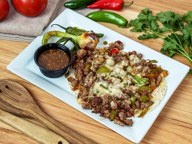 Alambres: grilled steak, peppers and onions under melted cheese
