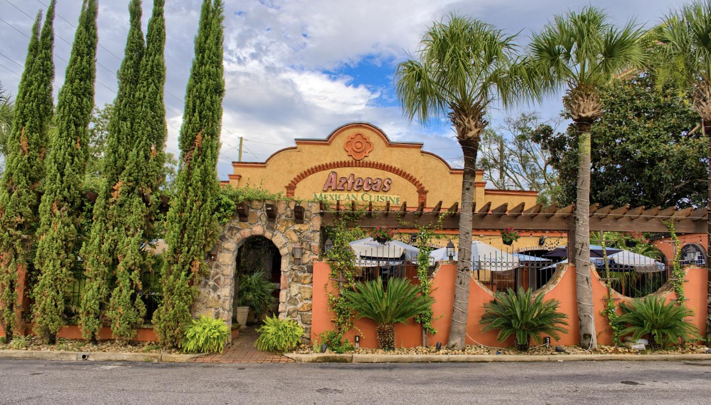 The Tillman's Corner storefront with its stone archway and palms